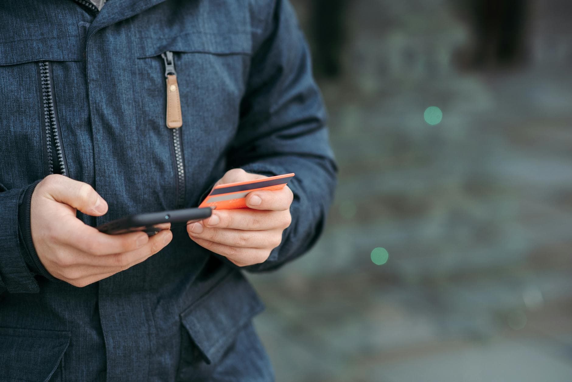A person entering credit card details on a smartphone